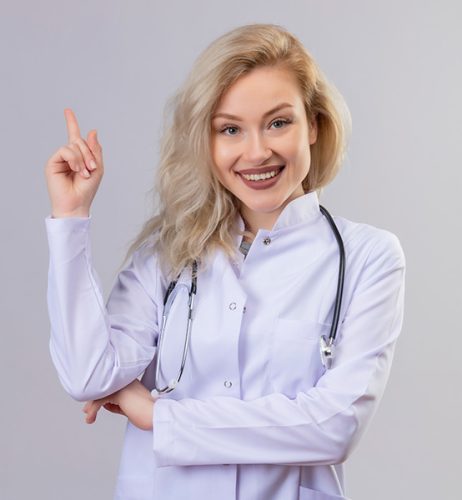 smiling-young-doctor-wearing-stethoscope-medical-gown-points-side-white-wall